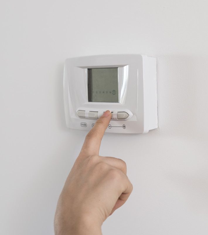 richtig-heizen Zeigefinger tippt auf Knopf eines Thermostats